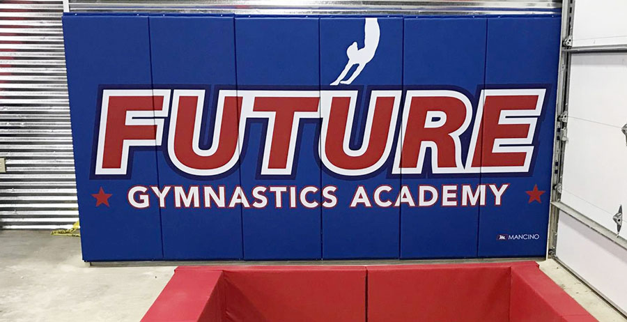 future gymnastics academy wall padding near in-ground pit